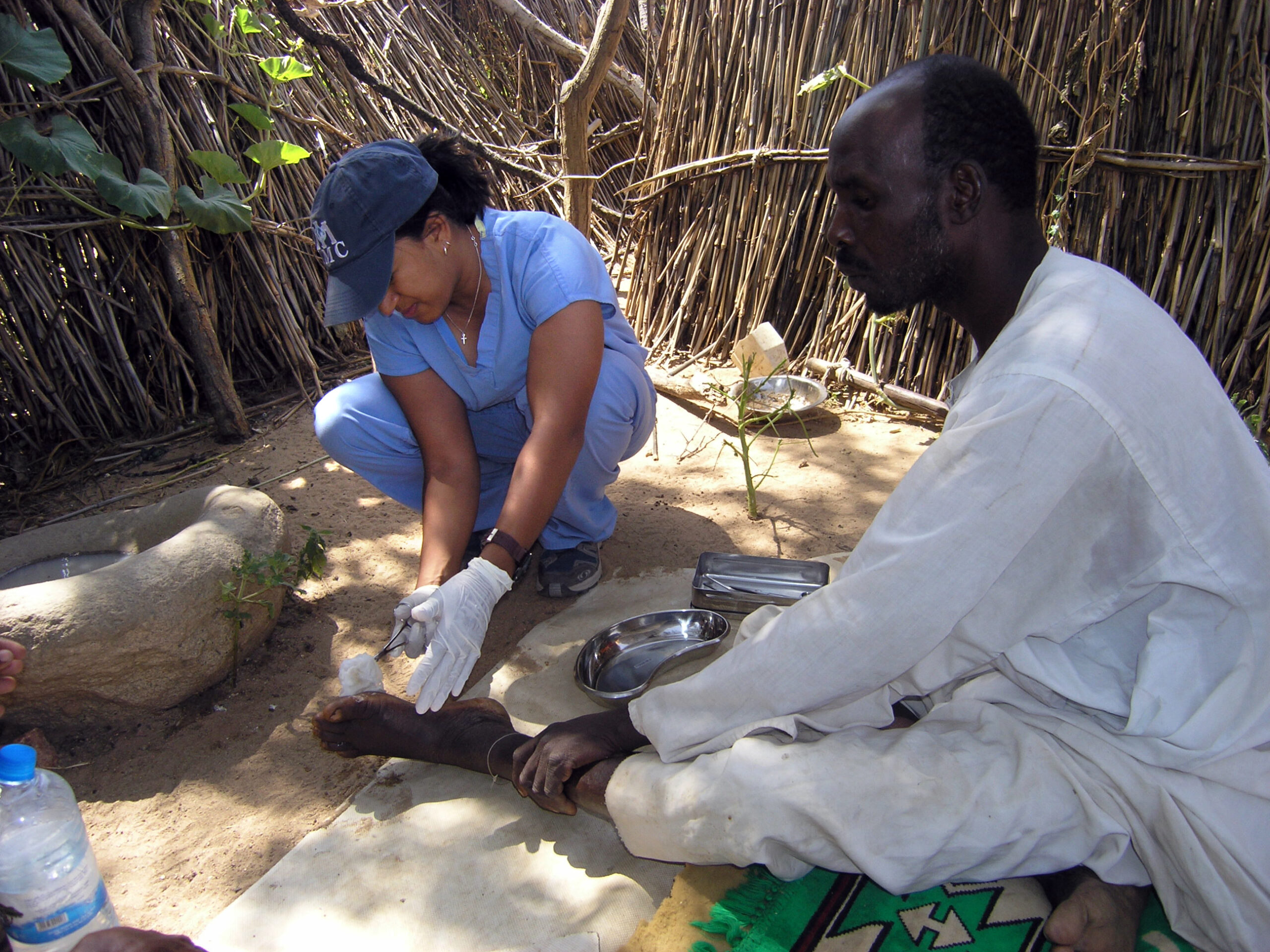 Dr. Jill John-Kall treats a wound on a patient’s foot while working with International Medical Corps in Chad in 2005.