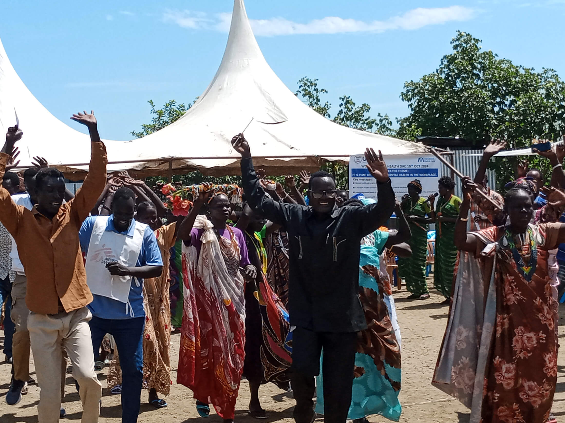 Community members in Malakal dance during the World Mental Health Day celebration, where International Medical Corps and local partners held mental health awareness sessions and other activities.