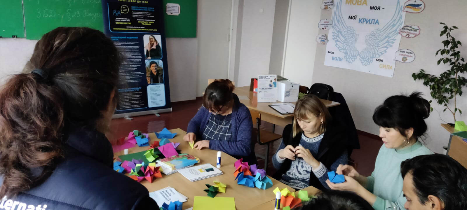 An International Medical Corps MHPSS worker leads the origami session for schoolteachers in Sofiivska.