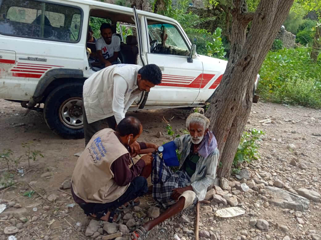 Two members of the CRT perform a medical checkup for a man in Al Azariq District.