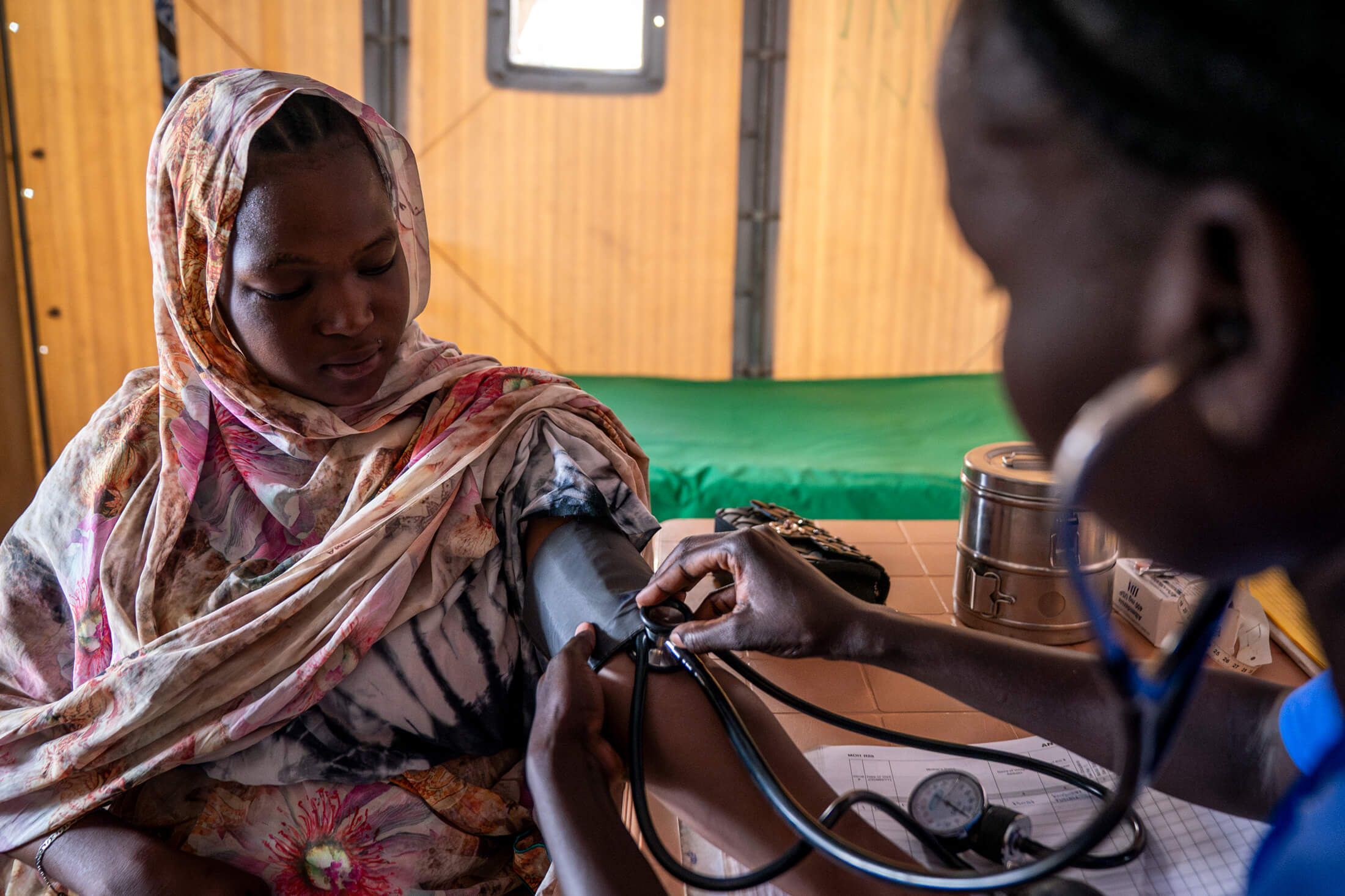 A woman gets her blood pressure checked by our staff.