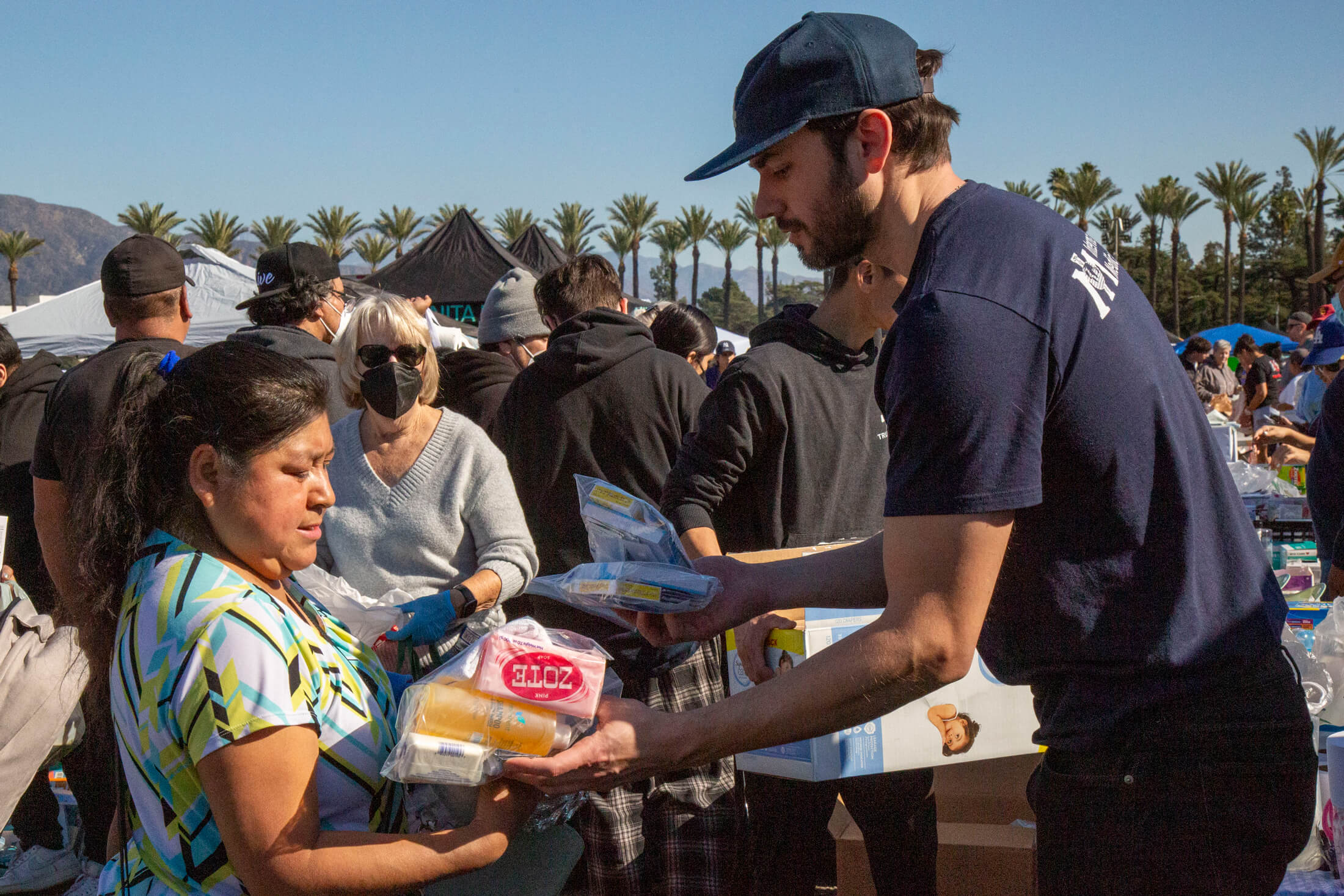 International Medical Corps staff member Ryan Haliday distributes shower and first-aid kits to fire-affected residents.