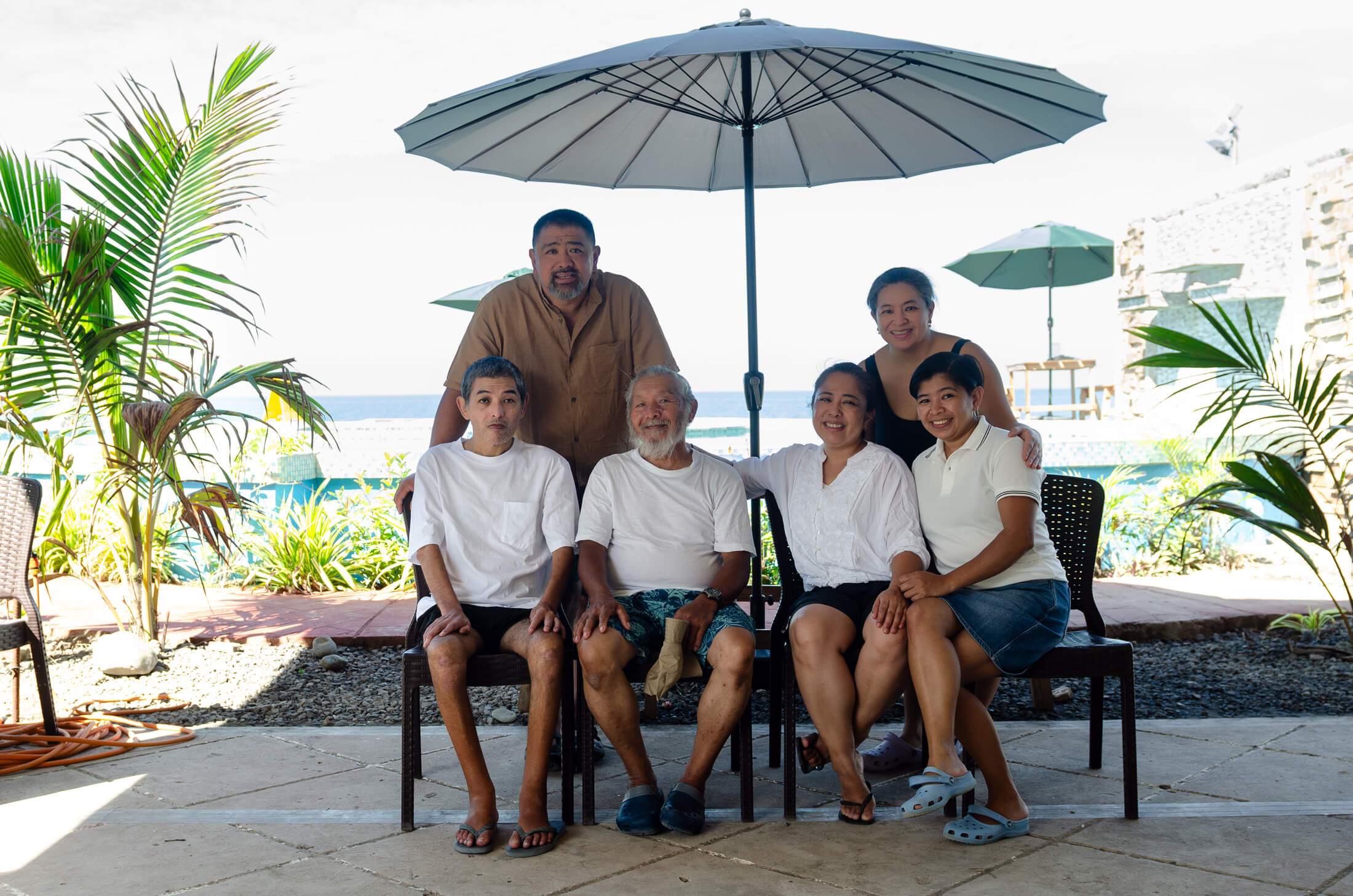 Dr. Bernardita Gaspar (seated, second from right) with her father and siblings at a family dinner in the Philippines in June 2023.