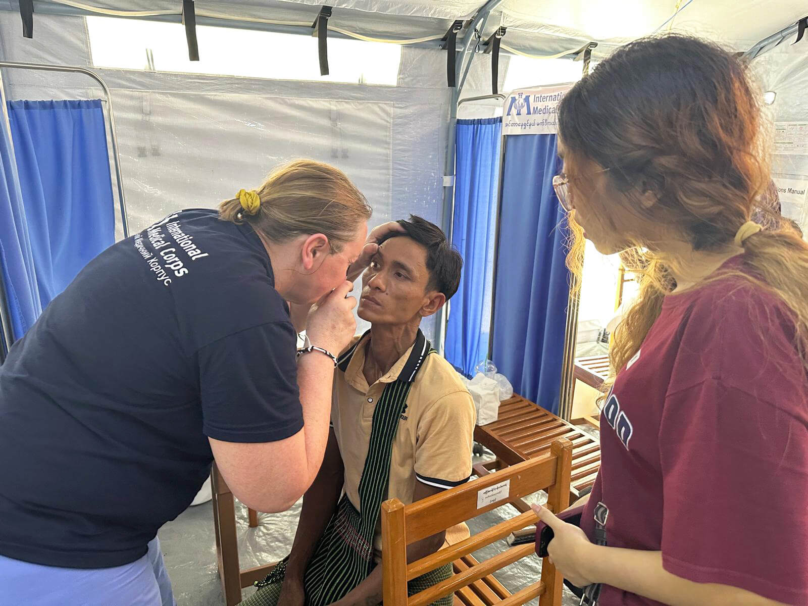 A member of our Emergency Response Team examines a patient at our mobile field hospital.