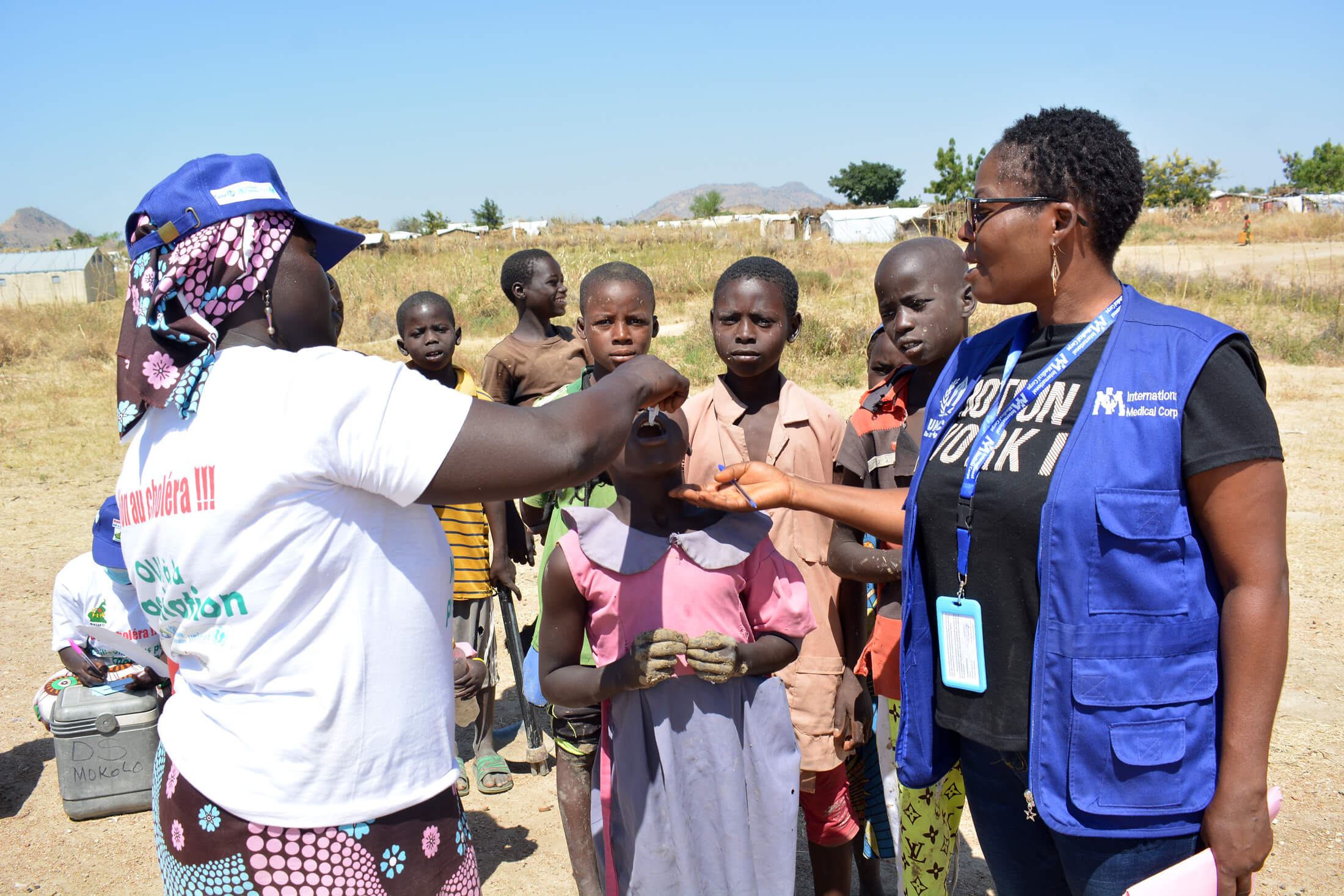 International Medical Corps team members administer the oral cholera vaccine to a child at Minawao Refugee Camp in Cameroon.