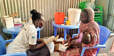 An International Medical Corps nurse in Malakal meets with a mother and her child who were referred to one of our nutrition sites by a community nutrition volunteer.