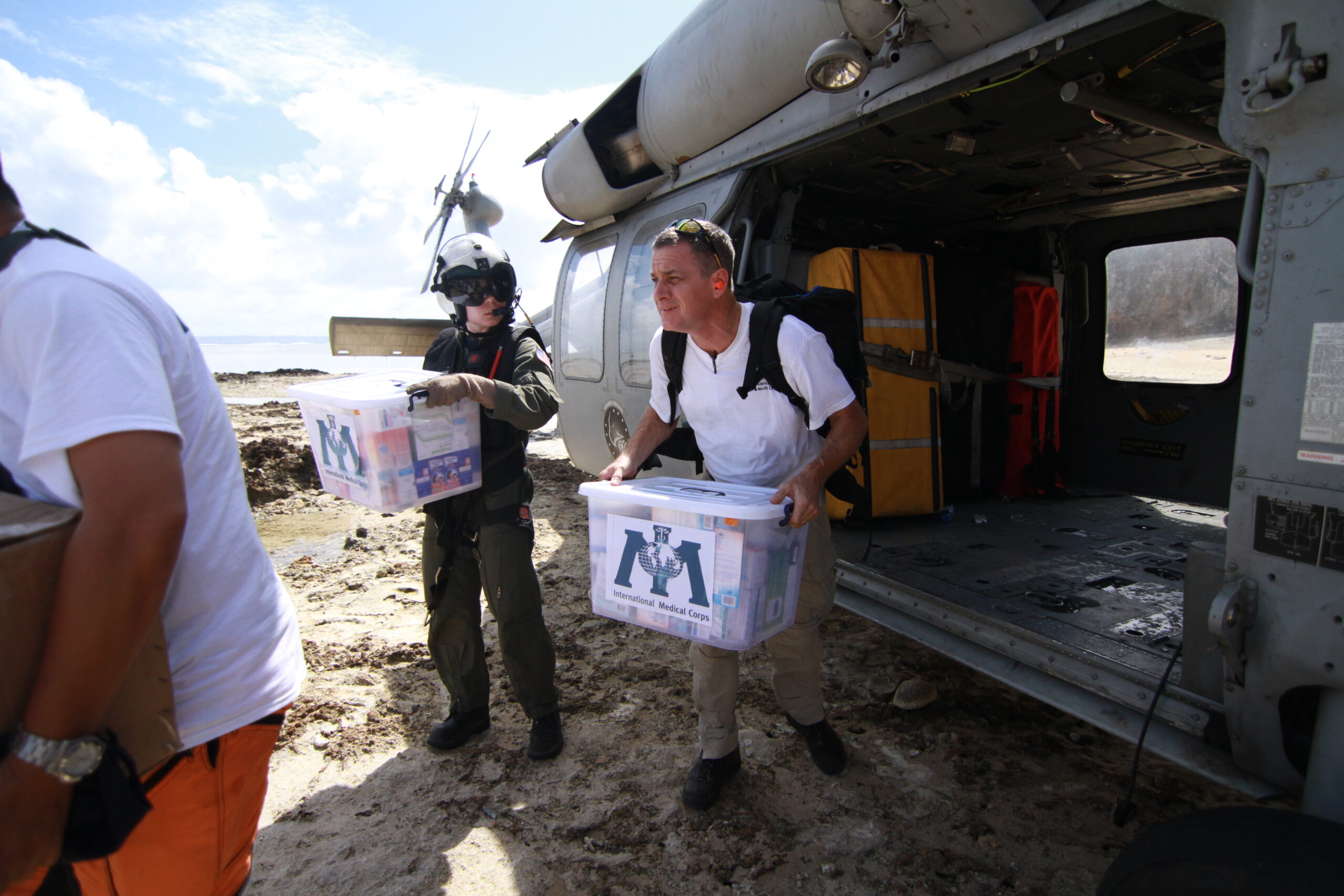 Dr. Fuller steps out of an emergency helicopter carrying supplies for our response efforts after Typhoon Haiyan in the Philippines in 2013.