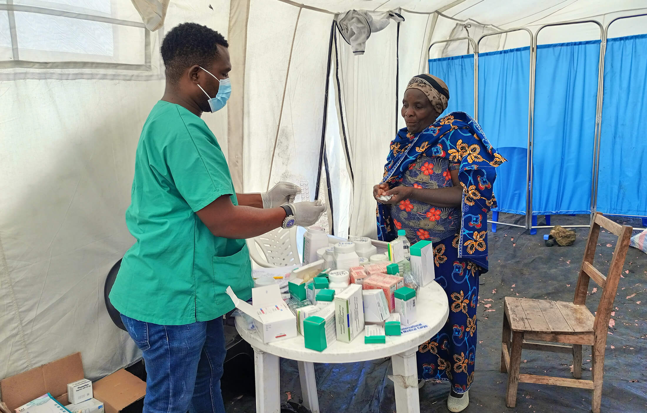 Esperance Hirhalihyandi (left), International Medical Corps Health and Nutrition Manager, provides medicine to Alice Borah, a patient in Kiliku village.