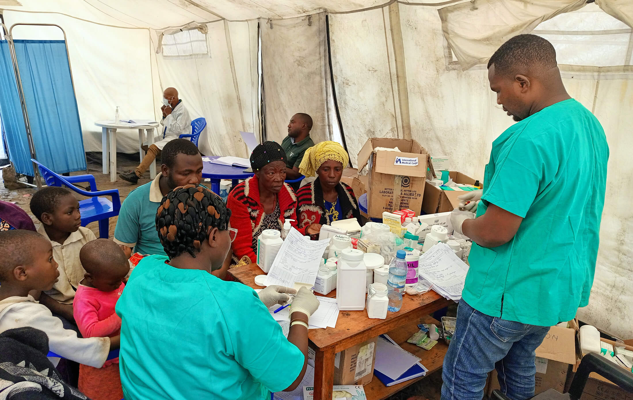 Staff member Jean Paul Cirhuza Matabaro distributes medications at a mobile clinic in Kirotshe health zone, North Kivu, DRC.