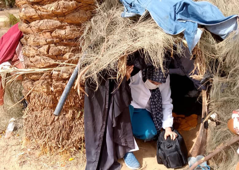 Nurse Hakimah exits the shelter after she and Dr. Fakhri treated A.C. for dehydration and exhaustion.