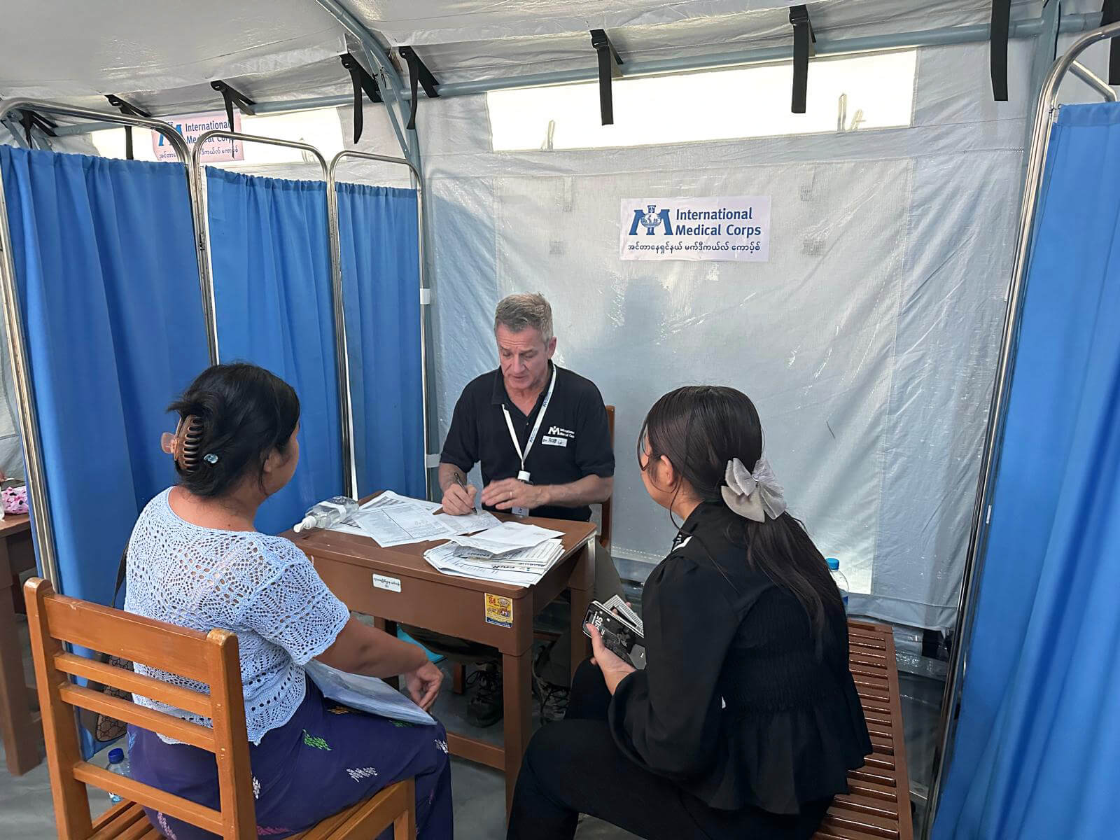 Dr. Fuller meets with patients at International Medical Corps’ mobile hospital in Pobba Thiri, Myanmar, in 2025.