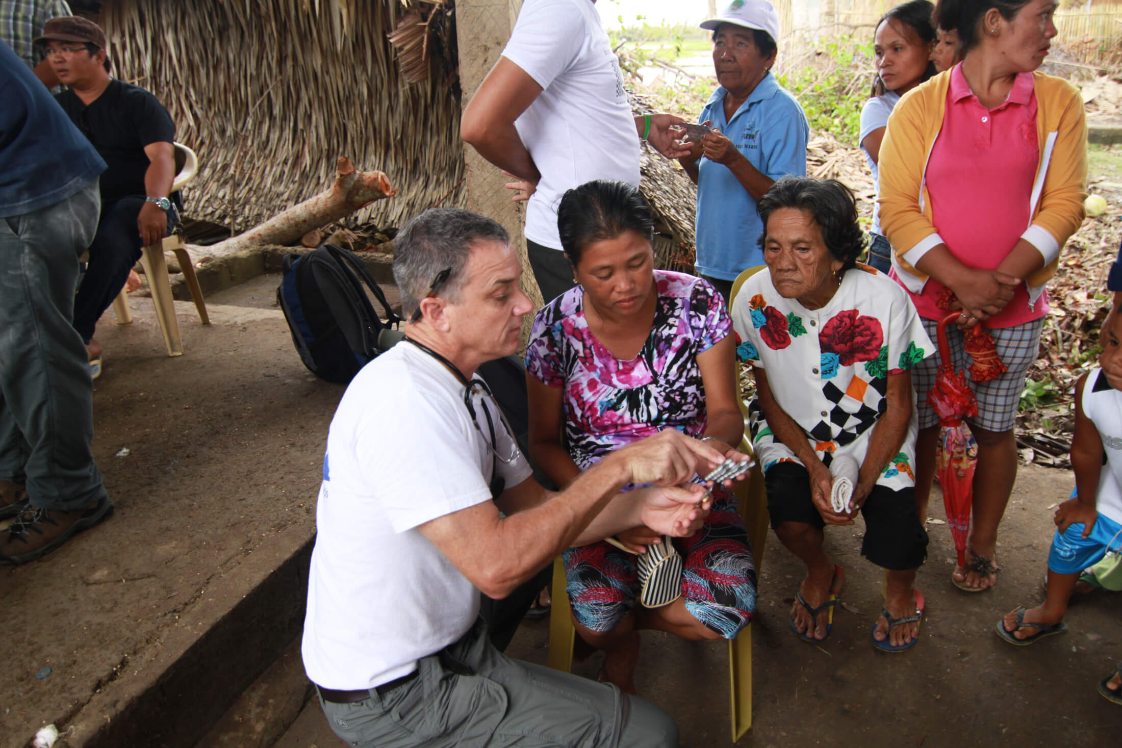 Dr. Fuller meets with patients in the Philippines, where he volunteered as part of our response to Typhoon Haiyan in 2013.