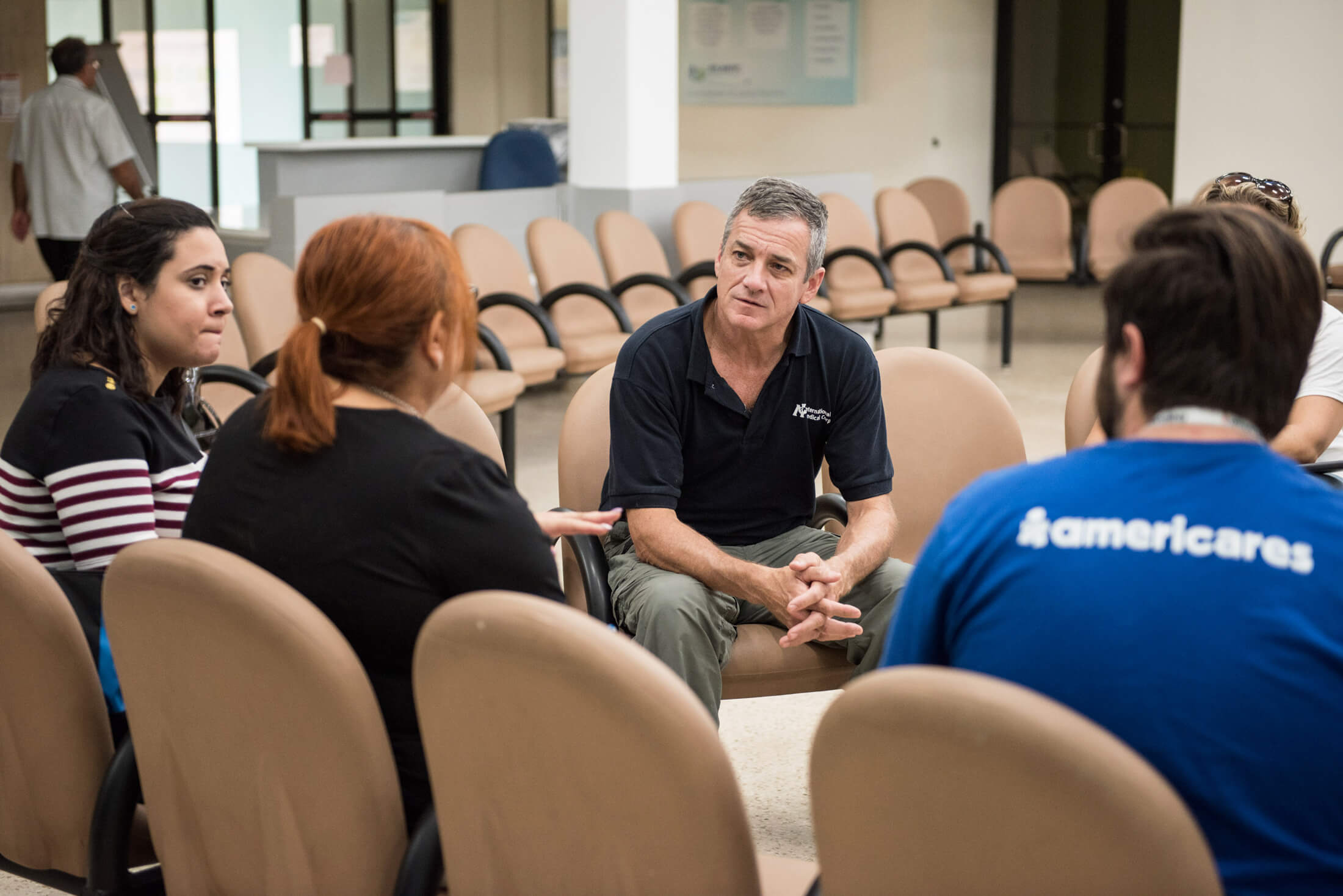 Dr. Fuller speaks with local health officials and Americares team members in Barceloneta, Puerto Rico, to help assess the damage from Hurricane Maria in 2017.
