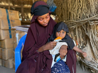 Sahro feeds Cimran therapeutic food she received as part of her malnutrition treatment.