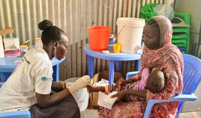 An International Medical Corps nurse in Malakal meets with a mother and her child who were referred to one of our nutrition sites by a community nutrition volunteer.