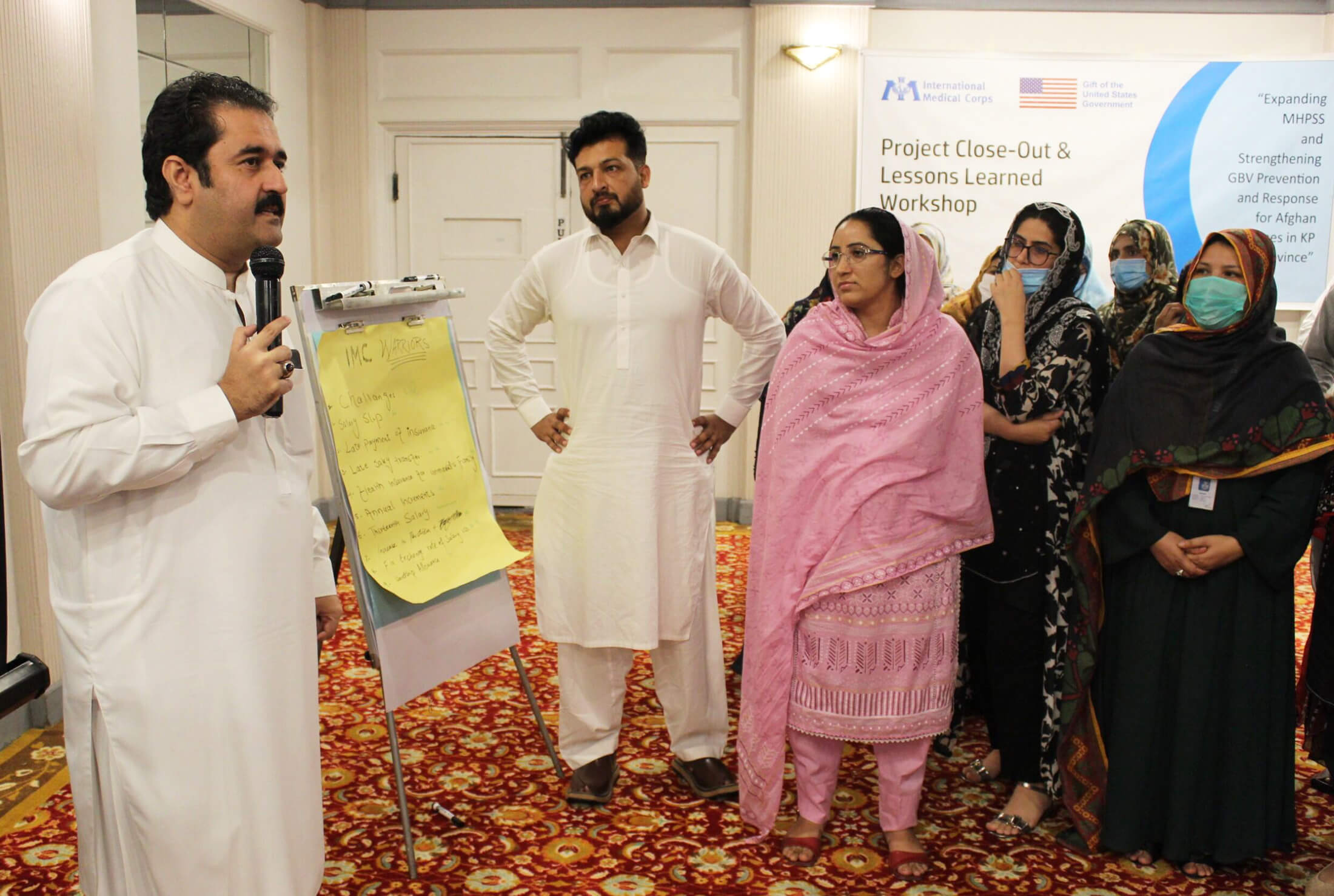 Pakistan Safeguarding Focal Point Waqar Hussein, left, gives a presentation on safeguarding.