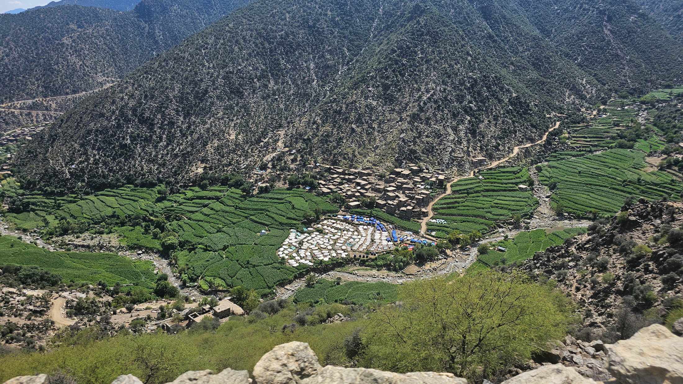Many earthquake survivors are living in temporary shelters, such as the white tents in this photo, in camps such as this one in a valley in Chawkay district, Kunar province.