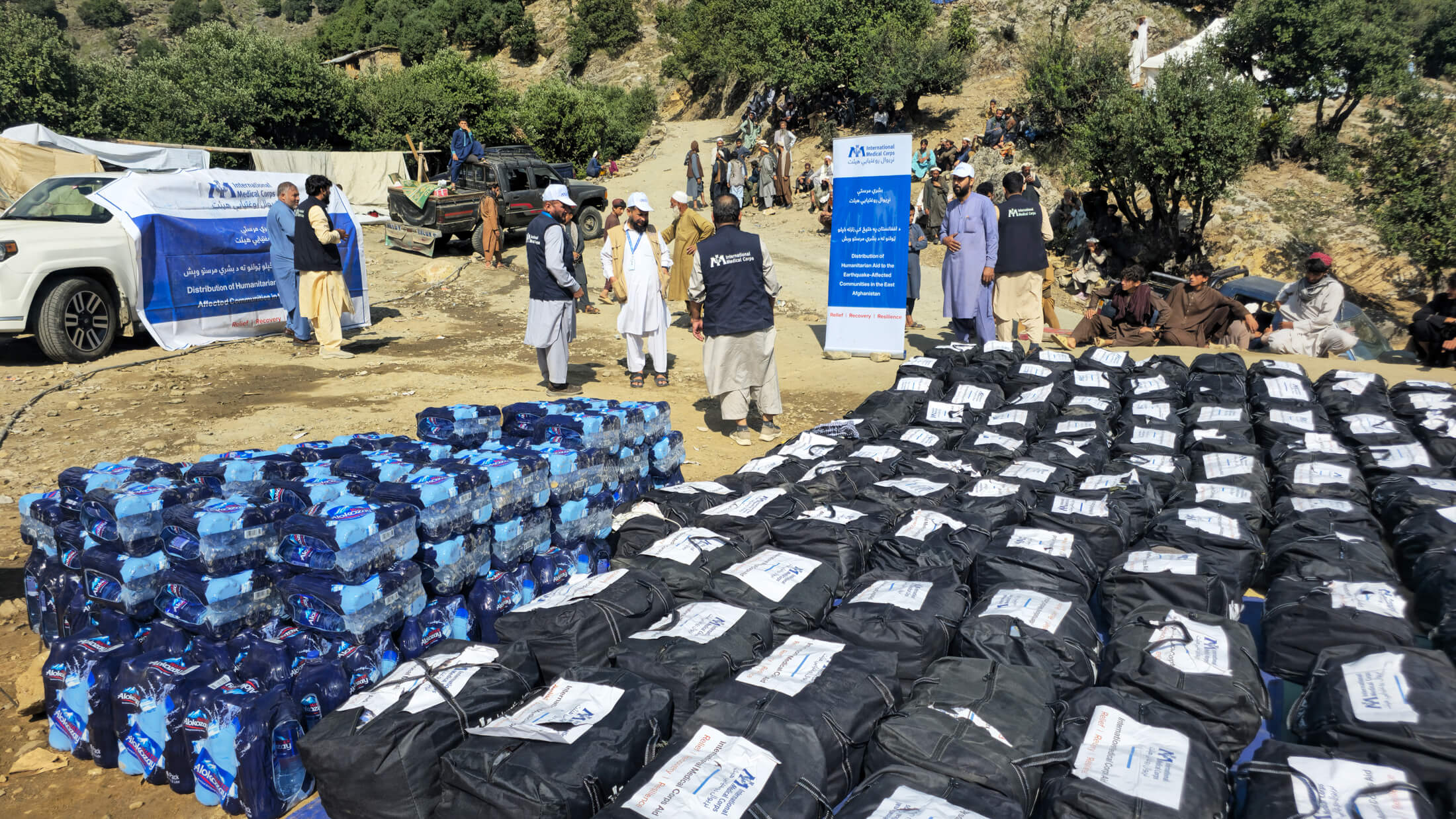 International Medical Corps staff distribute winterization kits and clean water at a distribution site in Chalas village.