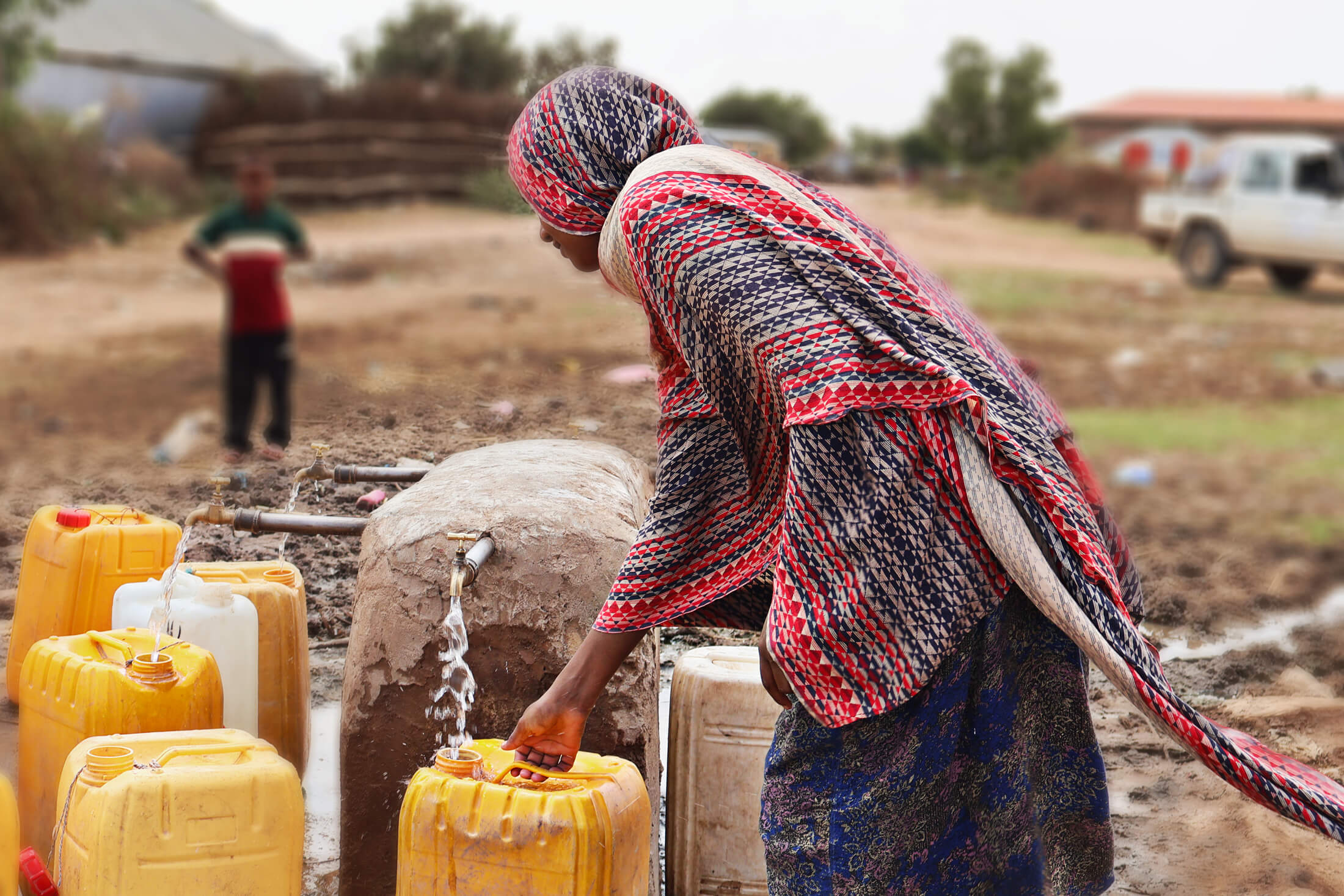Members of the community enjoy safe drinking water from an International Medical Corps-operated water system.
