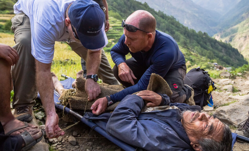 First responders treat a man on a stretcher during our response to the Nepal earthquake in 2015.