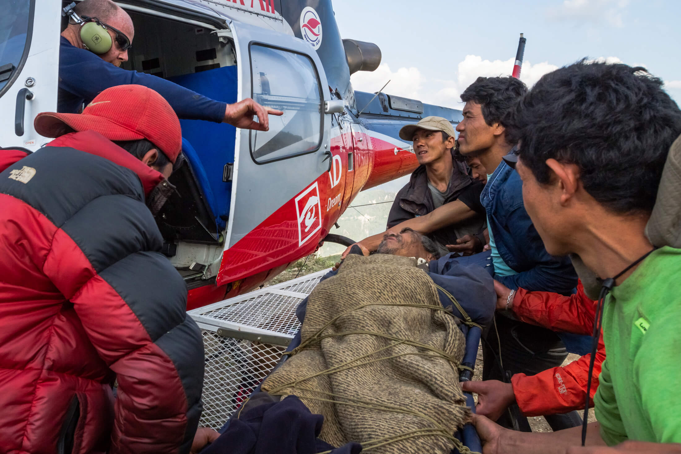 First responders treat a man on a stretcher during our response to the Nepal earthquake in 2015.