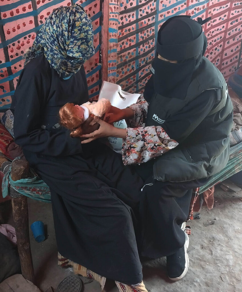 A CHNV in Yemen teaches a mother correct positioning for breastfeeding. Our CHNVs educate mothers on the importance of exclusive breastfeeding for the first six months after birth.