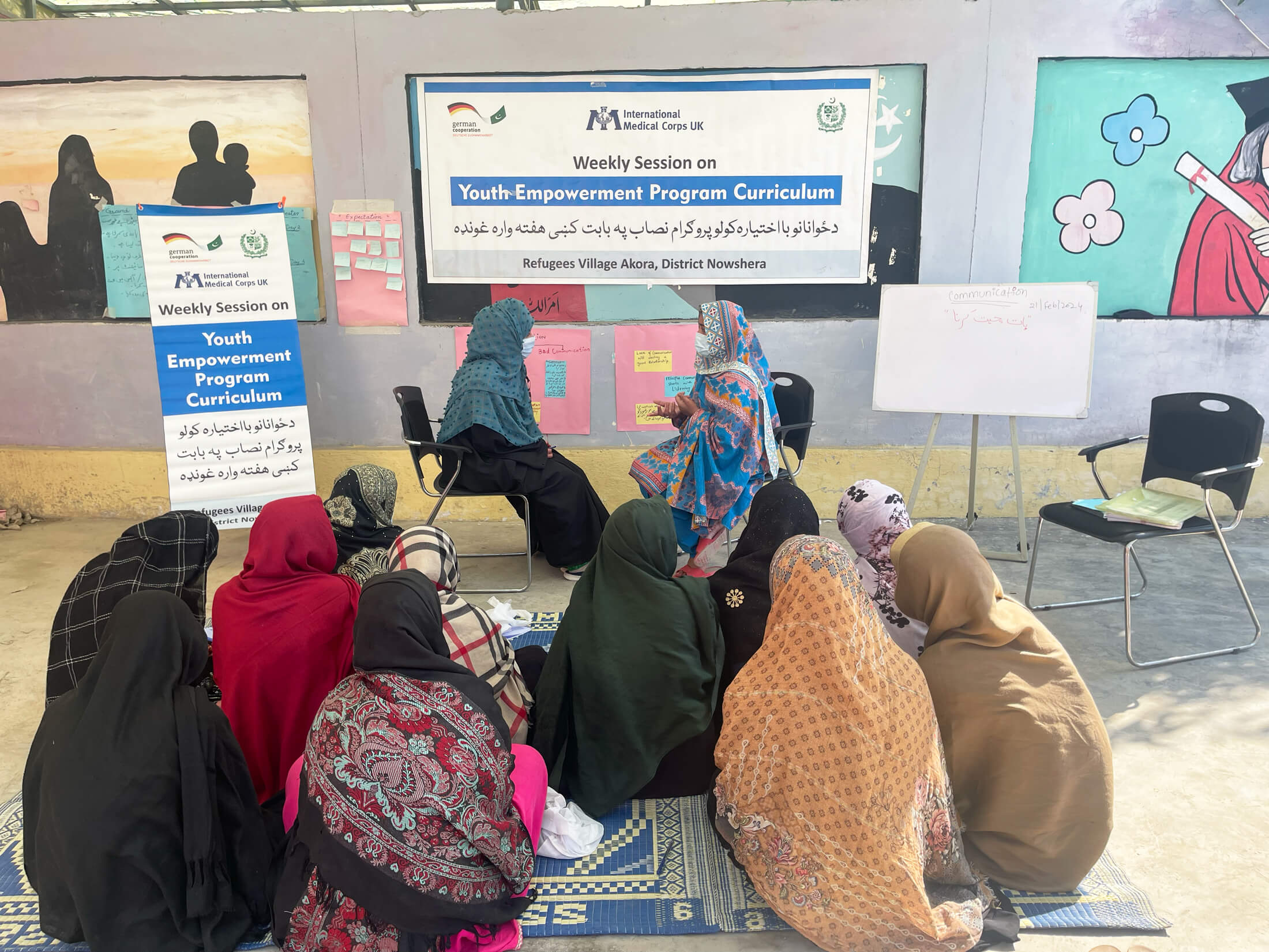 Female group members engage in a roleplaying activity as part of the programme.