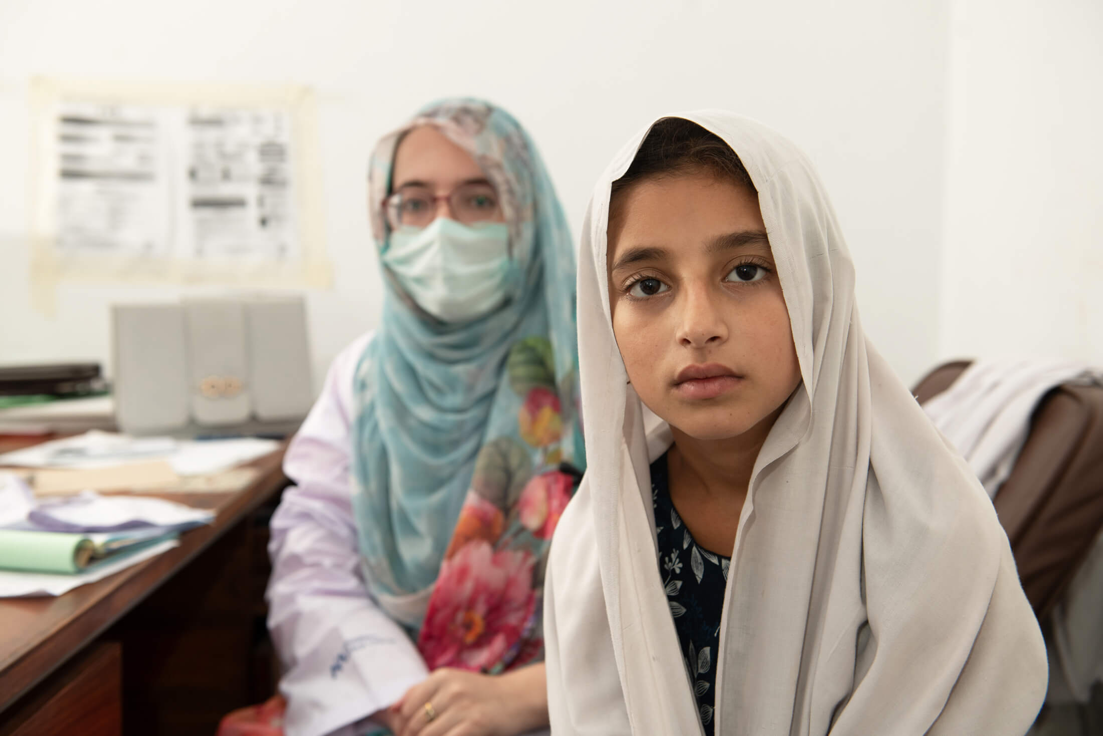 Alemat (right) meets with Dr. Shahista Ibrar at SPMK Category-C Hospital in Shangla district.