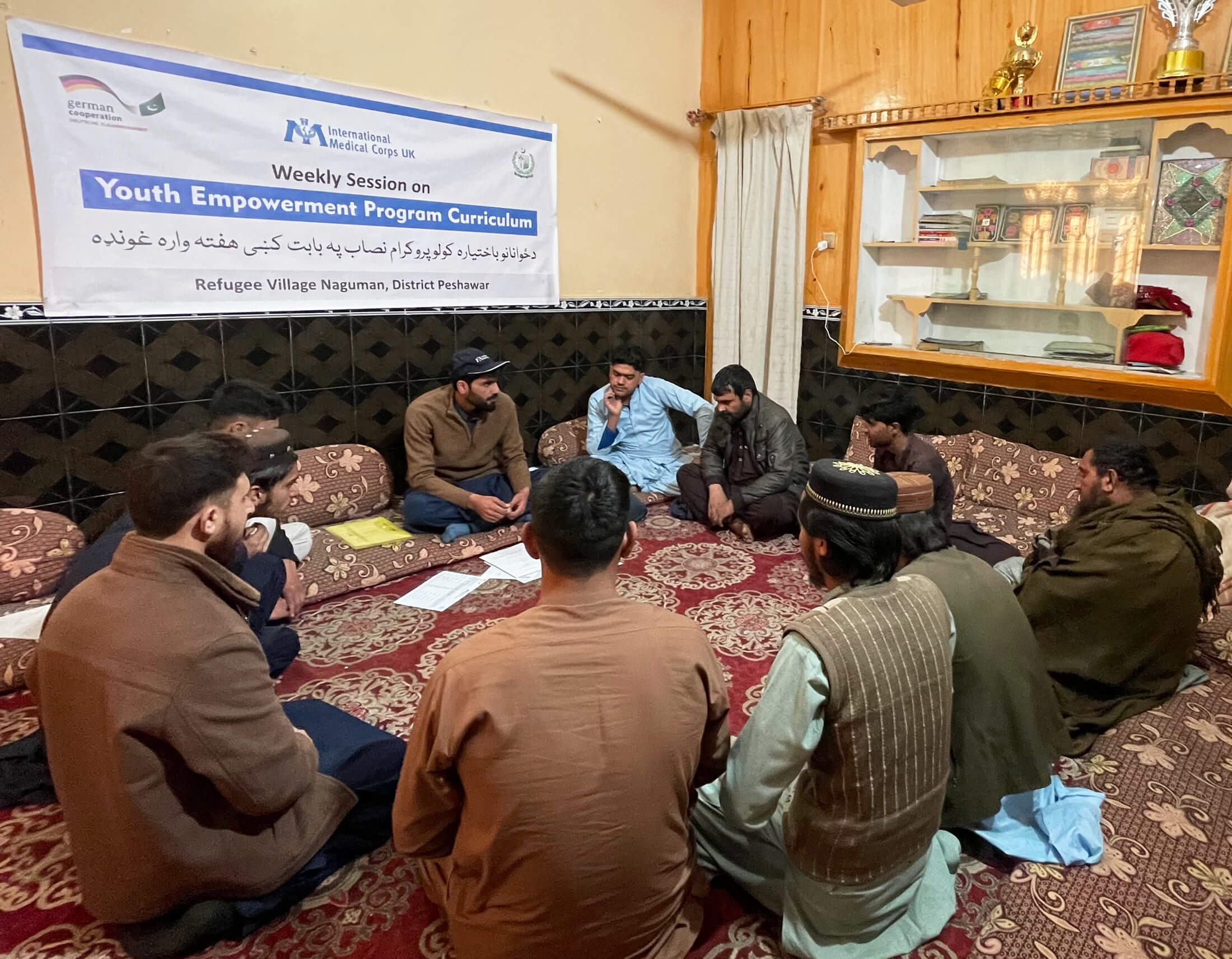Male group members discuss goal setting during a recent session led by Faiz Ullah, MHPSS Roving Social Worker with International Medical Corps.