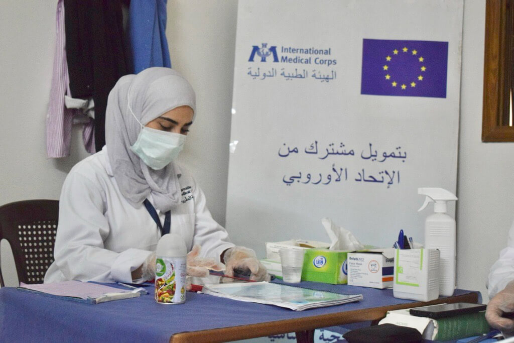 A gynecologist reviews the medical file of a patient at the Misraba MMT.