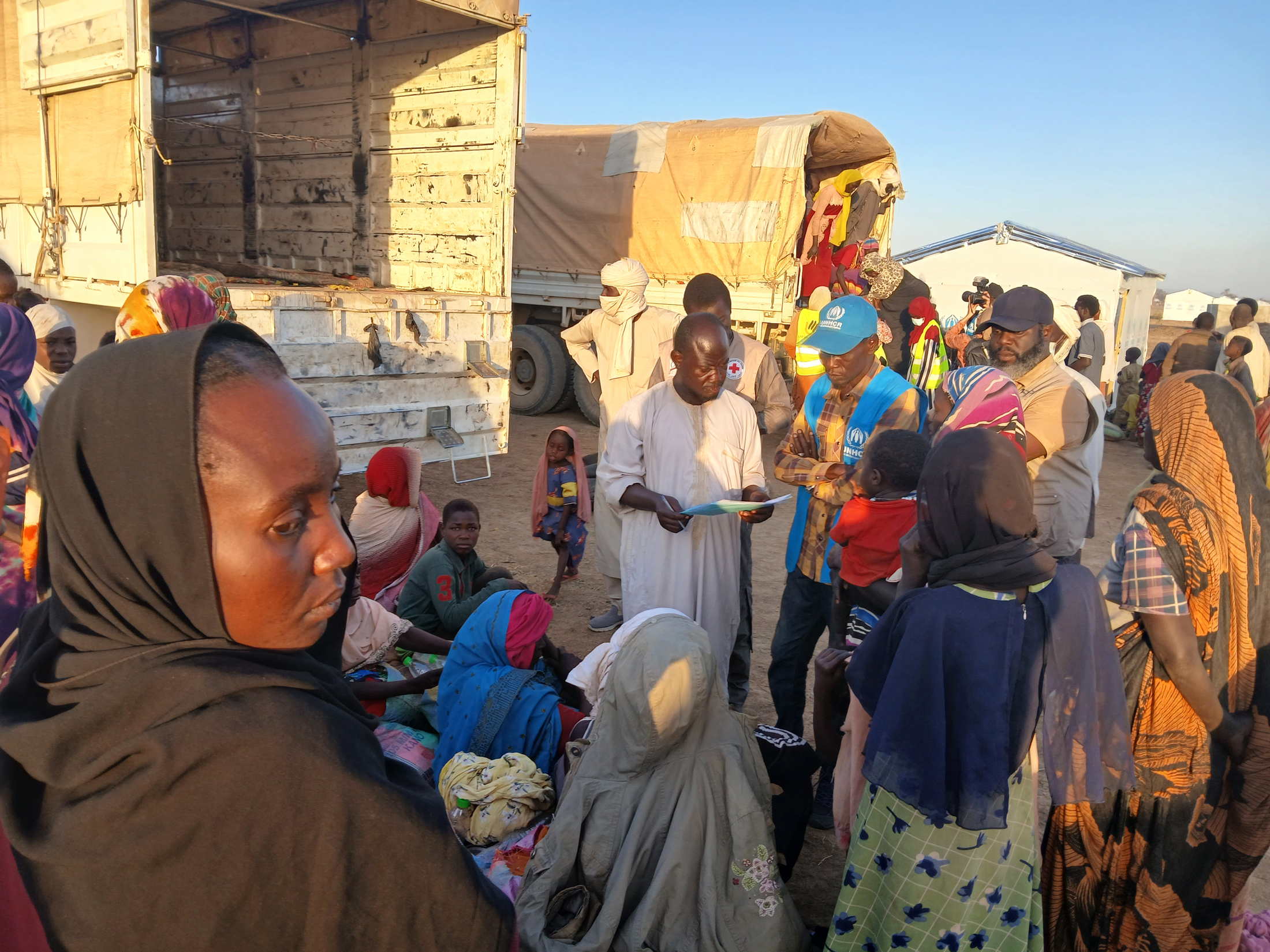 Dr. Germain (right, wearing a navy blue hat) receives Sudanese refugees arriving at Dougui refugee camp.