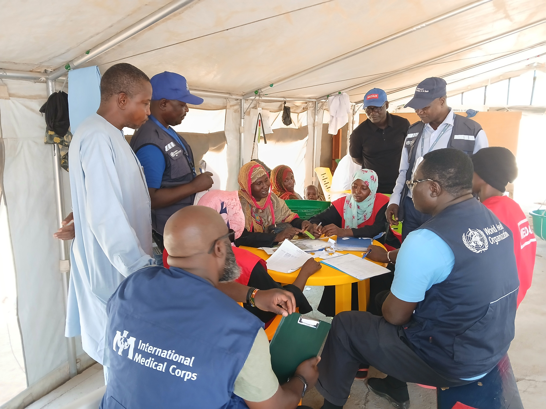 An emergency response team—including staff from the WHO, Chadian MoPH, International Medical Corps and Medair, as well as Chokoyane Health District community members—reviews epidemic surveillance protocol in Dougui Health Center in May.