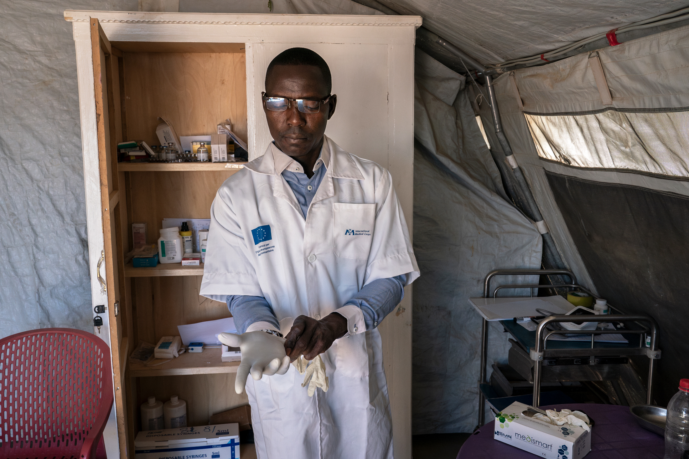 International Medical Corps nurse Valery Tarassim prepares to treat a patient at the Dougui refugee camp.