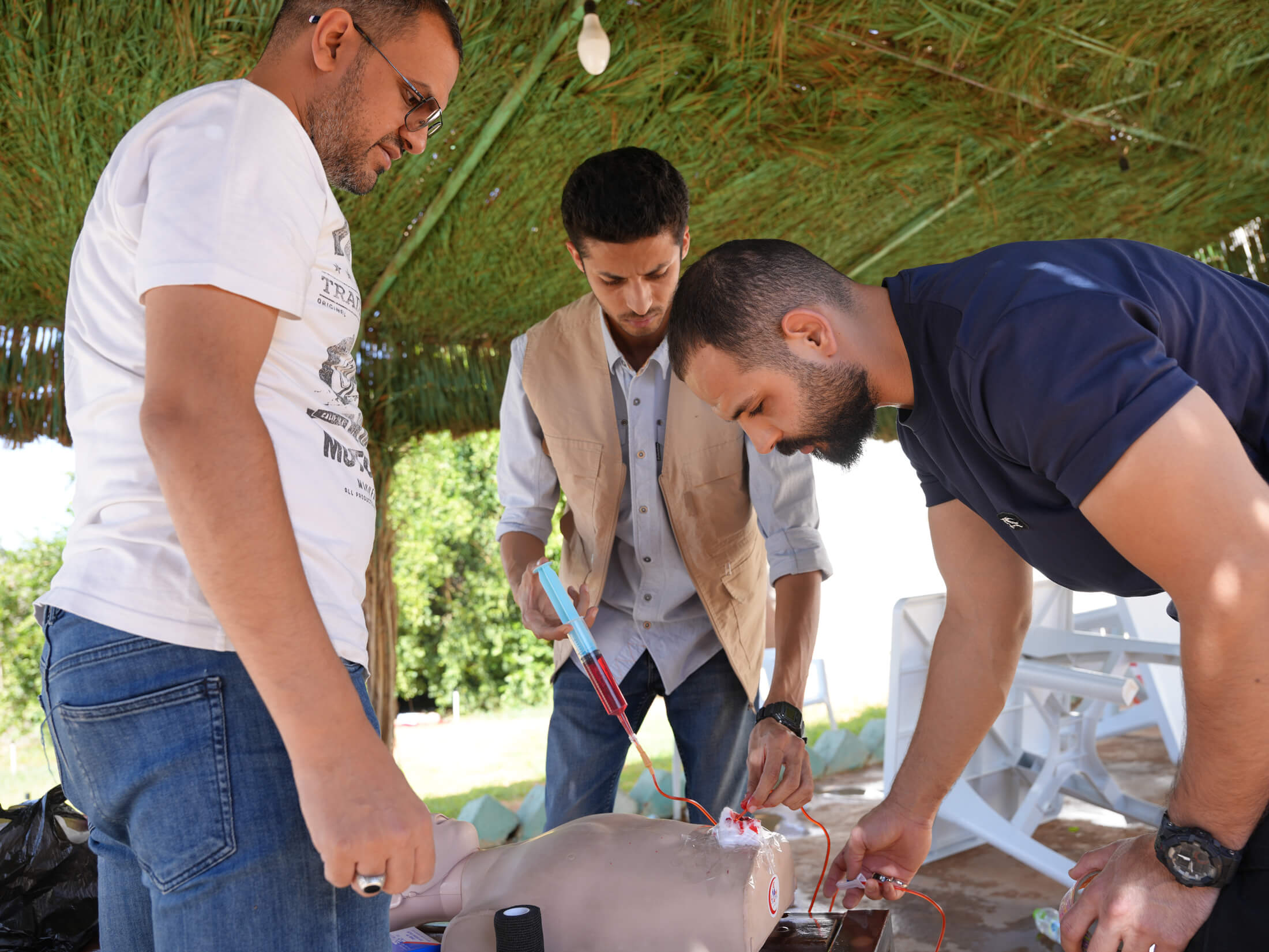 Drs. Abduraouf Abusalama (left), Ibrahim Shadi (centre) and Ahmed Fauzi set up the environment for the mass-casualty event simulation exercise.