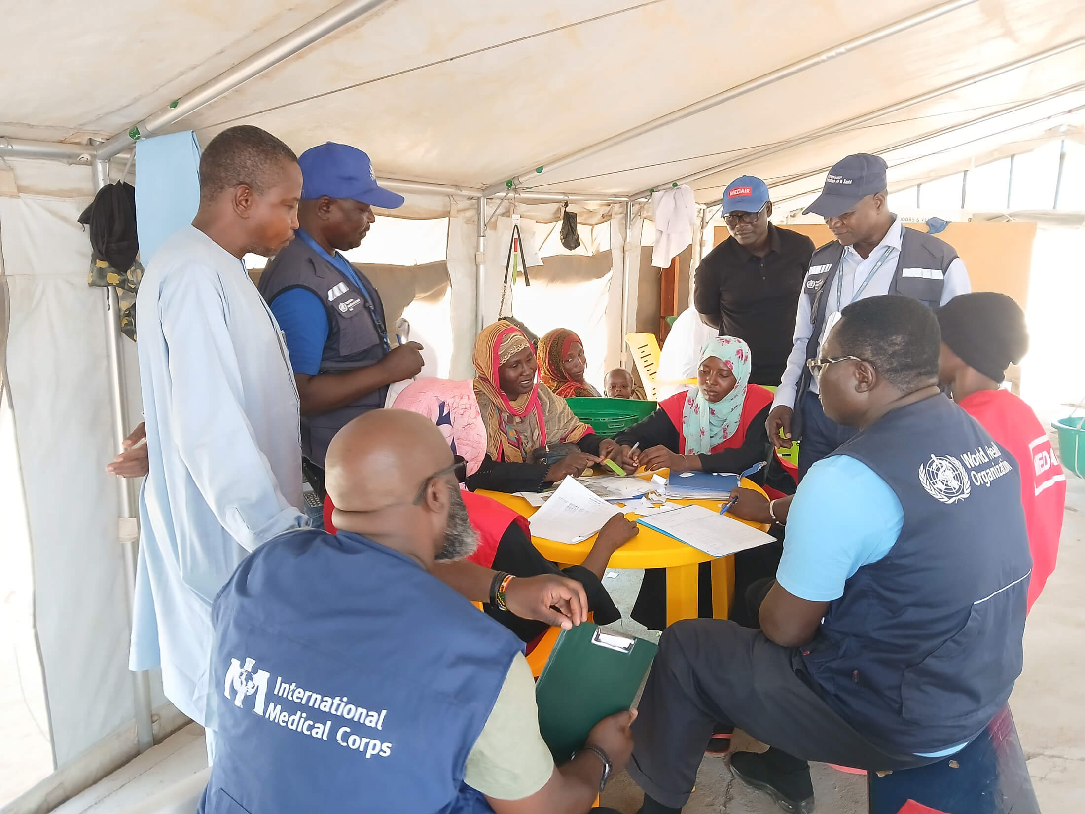 An emergency response team—including staff from the WHO, the Chadian Ministry of Public Health, International Medical Corps and Medair, as well as Chokoyane Health District community members—reviews epidemic surveillance protocol in Dougui Health Center in May.