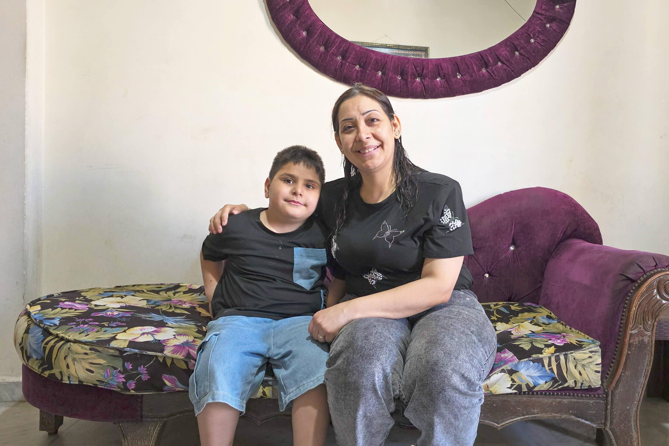 Mahmoud and Nisrine at their home. With support from International Medical Corps, Mahmoud underwent surgery for a urogenital condition he had since birth.
