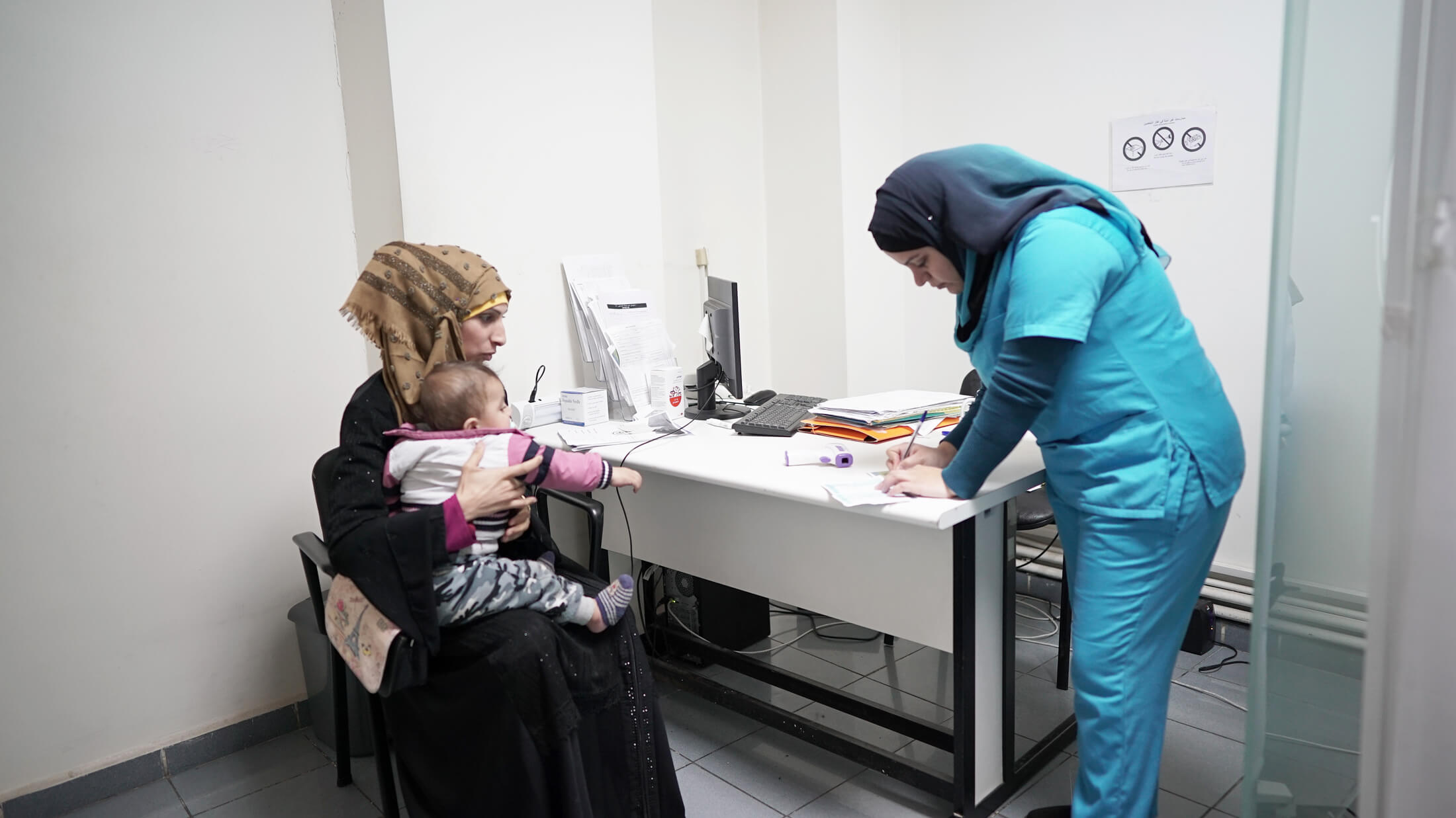 A woman and her baby during a routine health check-up at the Msaitbeh Primary Healthcare Center in Beirut. A fragile health system is making access to healthcare increasingly difficult.