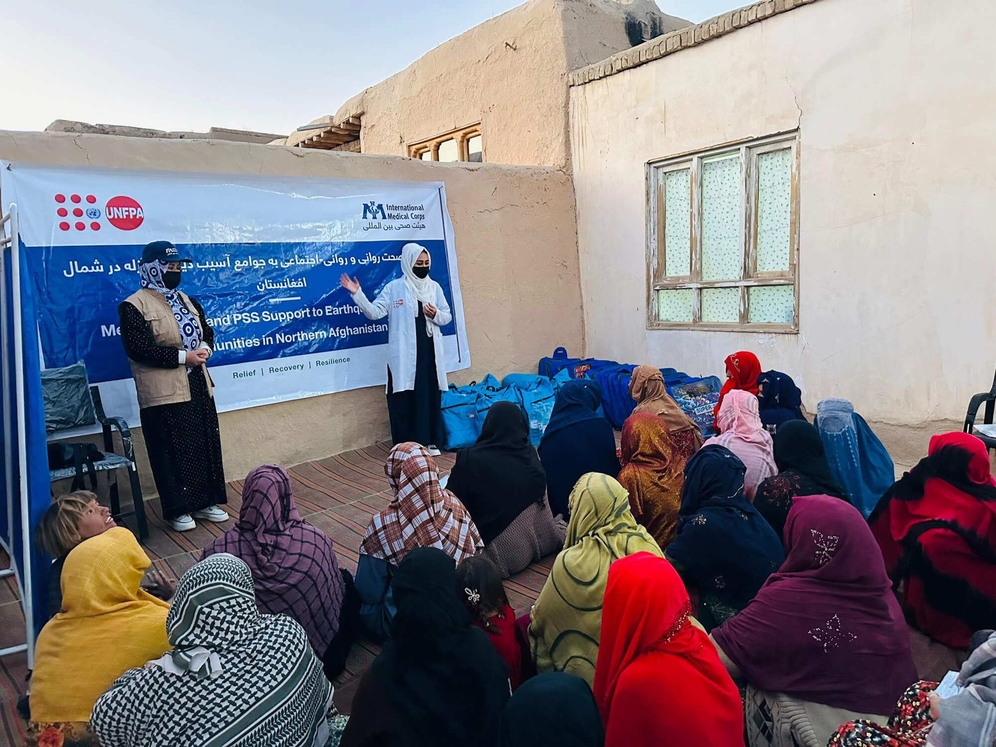 Staff members conduct a psychosocial support awareness session before distributing dignity kits in Samangan province for women affected by the earthquake.