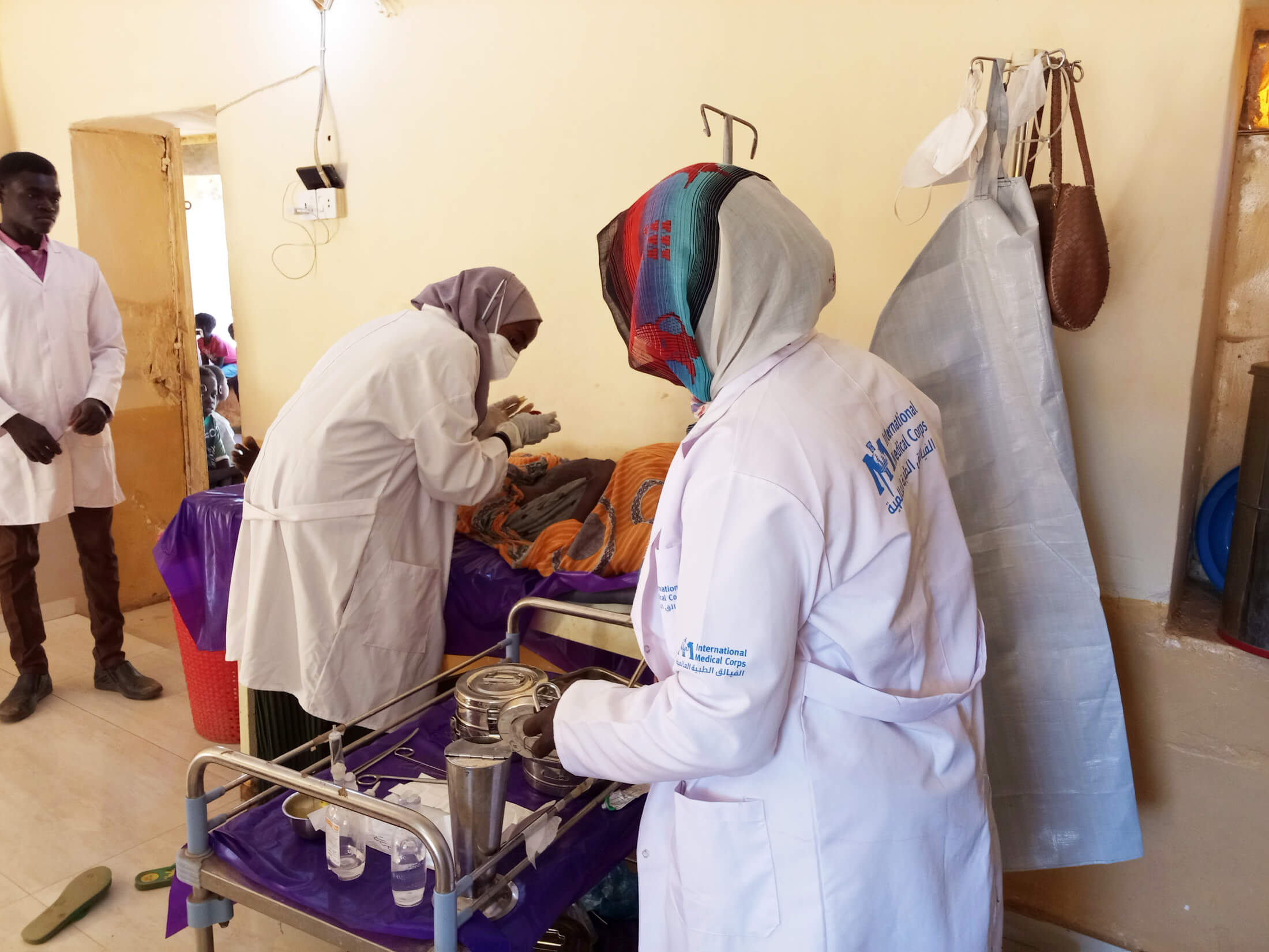 International Medical Corps staff members provide wound care at Souk Al Kadar Camp.
