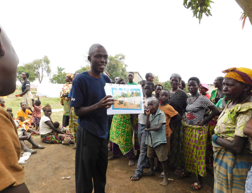 An International Medical Corps team member leads a cholera awareness and prevention training session at Bigo Health Center in the DRC in 2018. The health center was near a camp for displaced people, where cholera could easily spread.