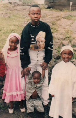 Abdou Sebushishe (centre, black shirt) stands with his siblings in Goma in 1998.