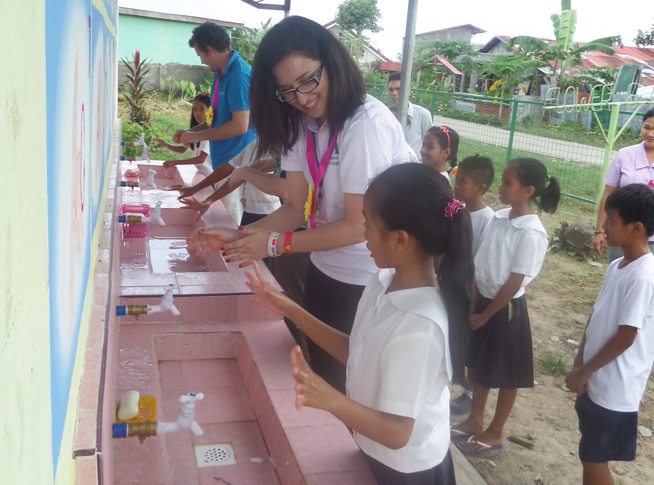 Suha practices proper handwashing techniques with children in the Philippines in 2013.