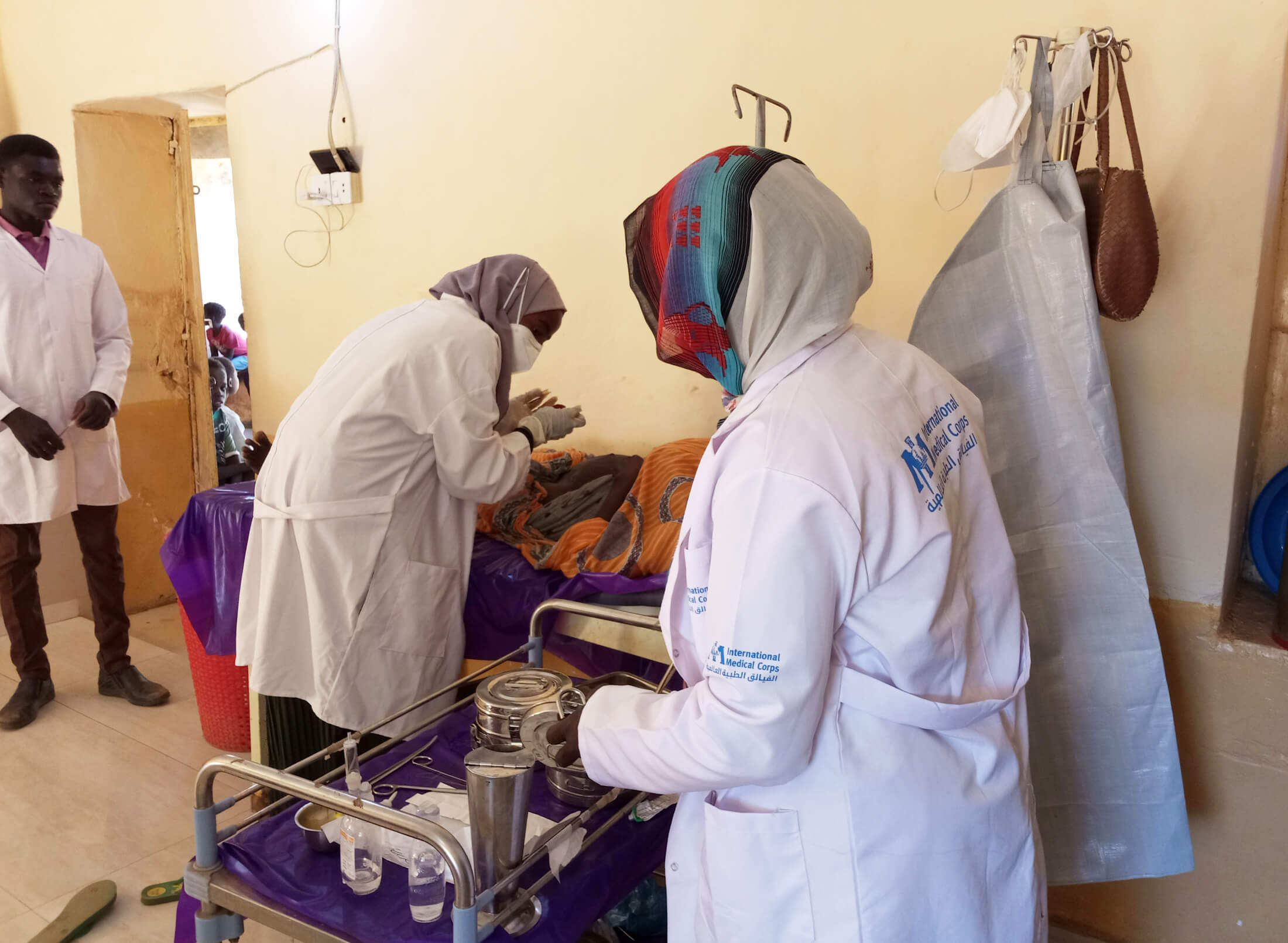 International Medical Corps staff members provide wound care at Souk Al Kadar Camp.