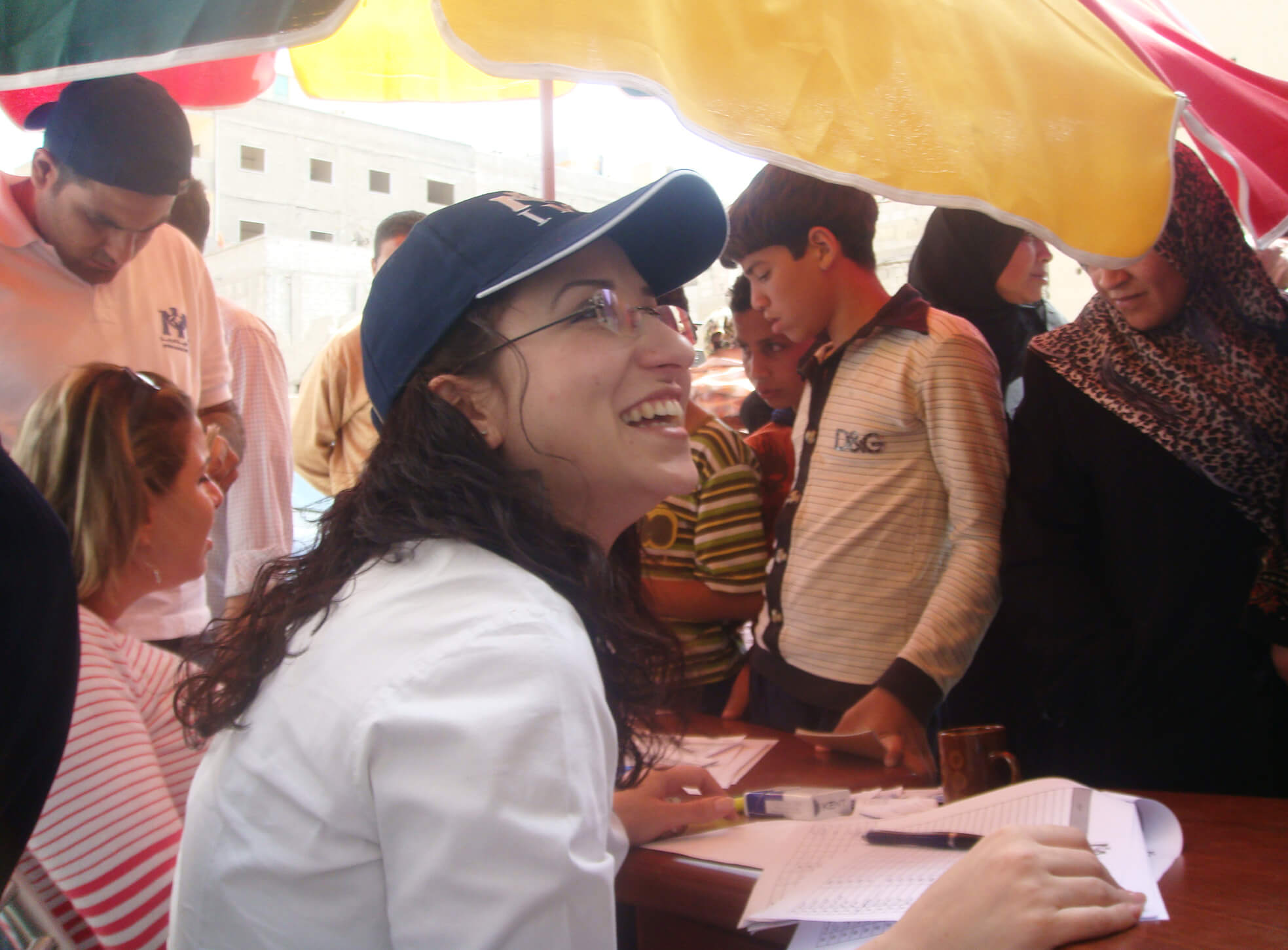 Suha sits at an intake desk at an International Medical Corps clinic in Syria in 2009.