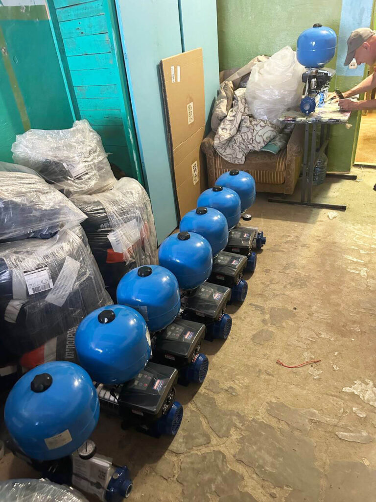 A staff member checks the quality of booster pumps before installing them in locations across the city of Pokrov.