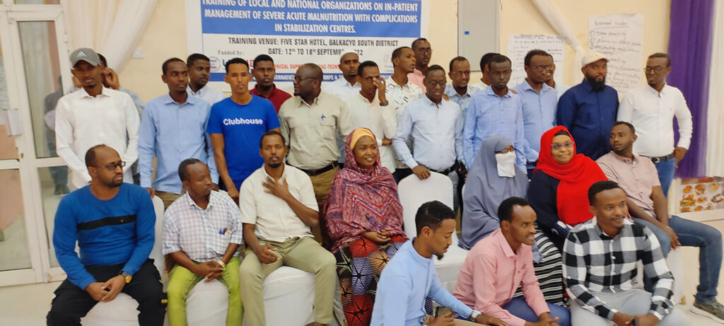Martha Nakakande (in yellow headscarf) is shown with participants of a weeklong inpatient care training for local partners in Somalia on the management of severe acute malnutrition.