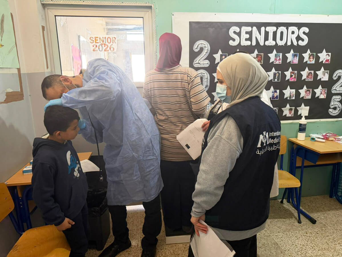 Physicians from the Mashael mobile medical unit examine patients at Haush Harimeh High School.