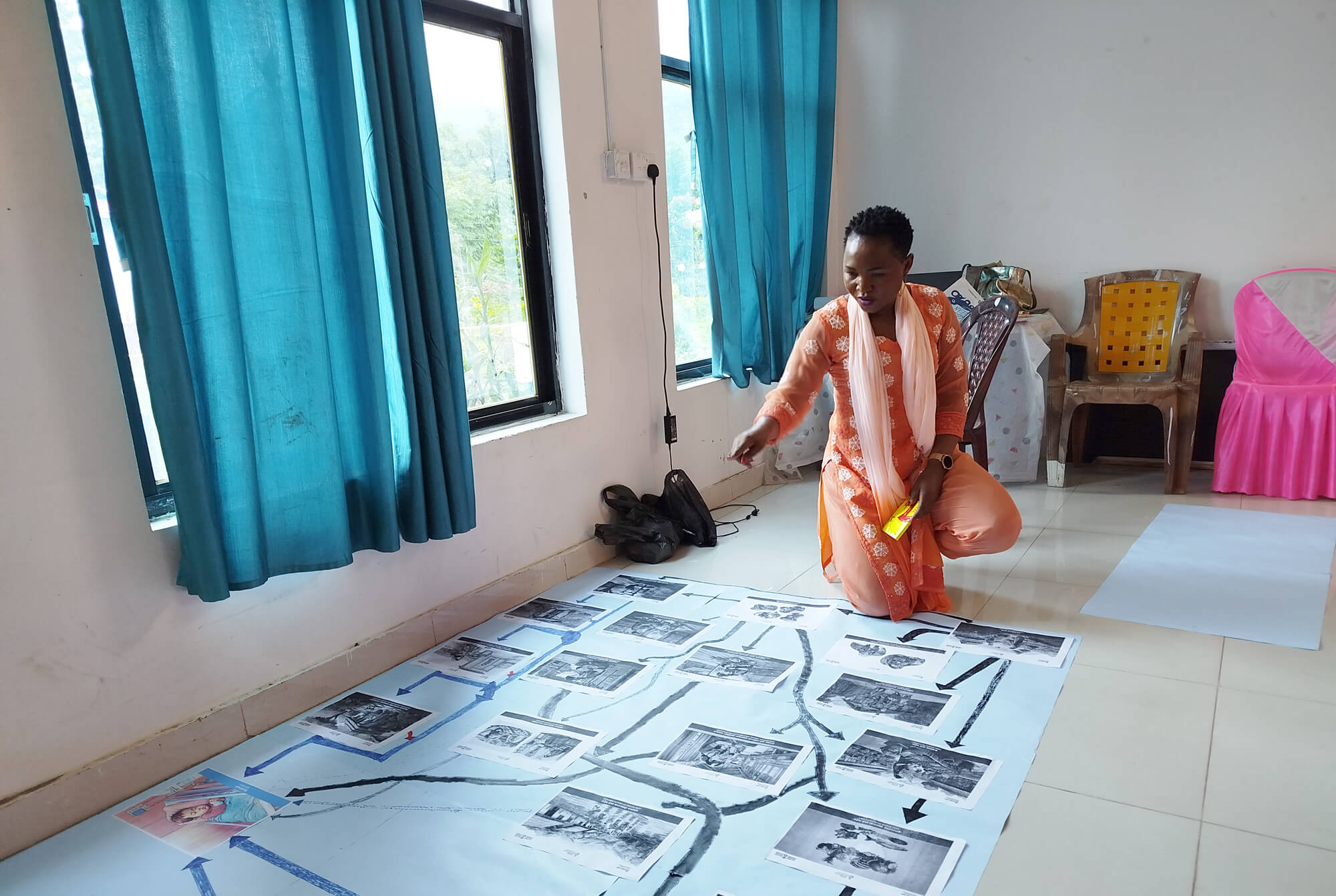 Martha Nakakande draws a pathway to be used at a workshop with key district leaders in Nepal.
