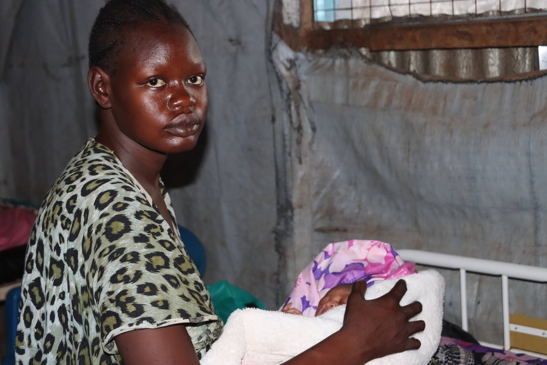 Nyaruot holds her son at International Medical Corps’ health facility at the Juba IDP camp.