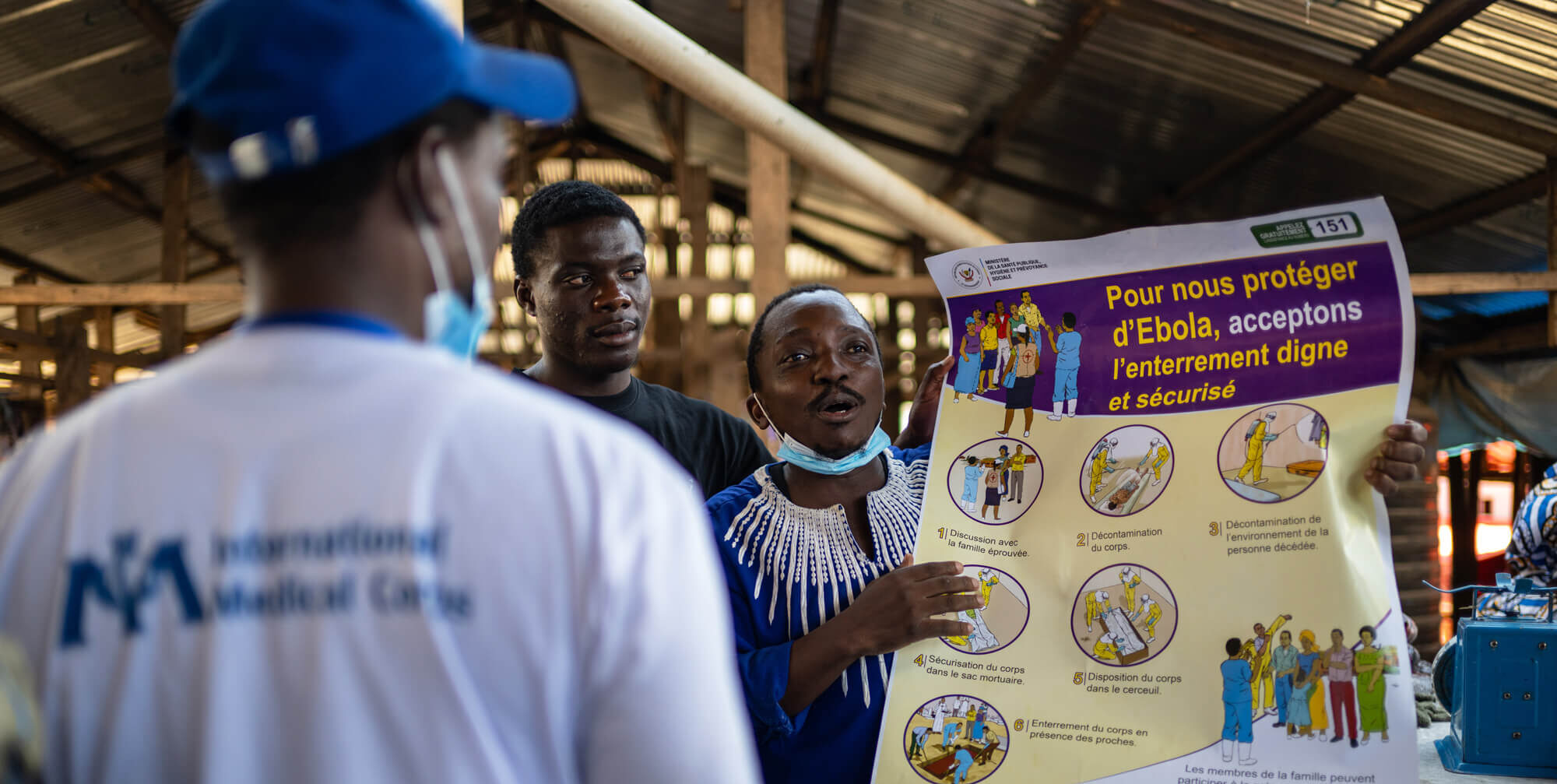 Pantient Kaswahili, one of the community health educators supported by International Medical Corps, conducts an awareness session on the prevention and symptoms of Ebola virus disease for vendors and visitors at the central market in Bunia, Ituri.
